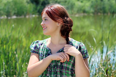woman in green and black plaid dress smiling thumbnail