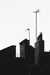 grayscale photo of concrete buildings with outdoor antennae thumbnail