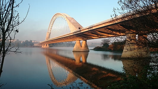 Grey Concrete Bridge Above Water Under Blue Sky thumbnail