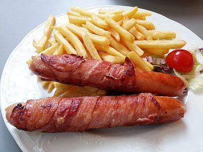 bacon wrapped sausages and fries on plate thumbnail