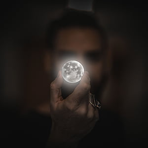 person holding moon artwork thumbnail
