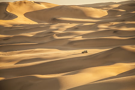 beige vehicle on sand dunes thumbnail