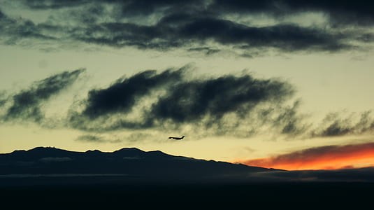 silhouette under cloudy sky thumbnail