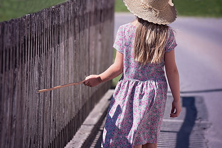 woman wearing floral dress beside gray fence thumbnail