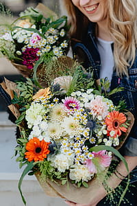 Young woman with basket full of flowers thumbnail
