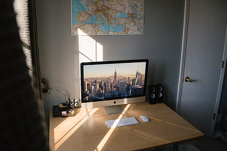 silver iMac on top of brown desk beside window area thumbnail