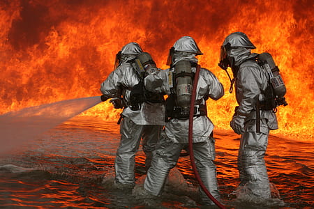 three firefighter holding hose in front of blazing fires thumbnail