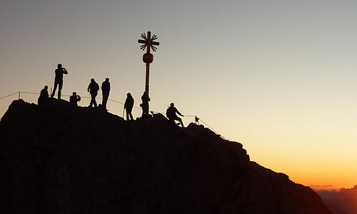 silhouette of group of people on hill during golden hour thumbnail