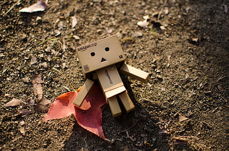 brown cardboard man lying on ground thumbnail