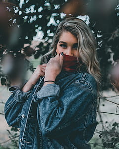 women's covering her face with blue and red denim jacket thumbnail