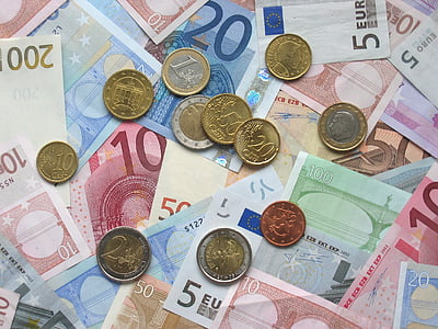round gold-colored coins on banknotes thumbnail