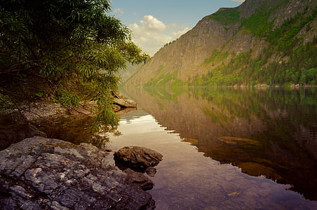 photo of mountains near body of water thumbnail