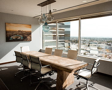 photo of rectangular long table with rolling armchairs inside room thumbnail