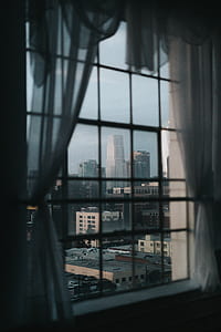 overlooking city buildings through glass windows thumbnail