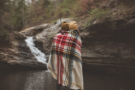 two people inside gray and red plaid blanket at waterfalls thumbnail