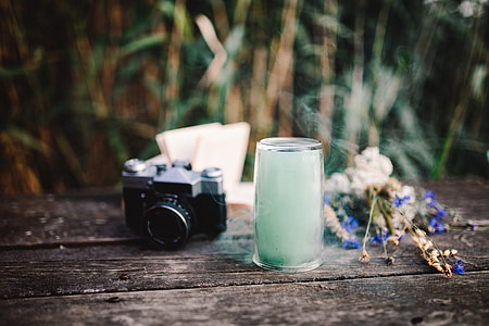 Colorful smoke bomb, book and vintage camera thumbnail