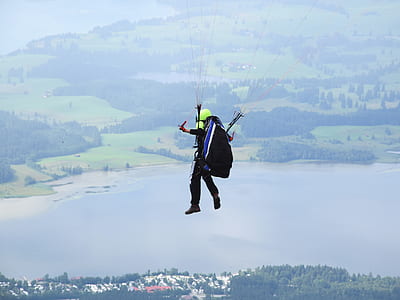 person paragliding at daytime thumbnail