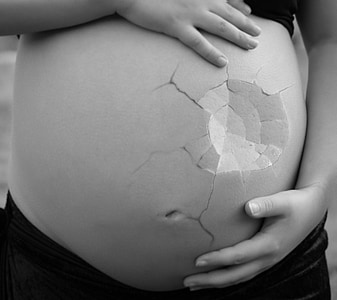 woman holding her tummy thumbnail