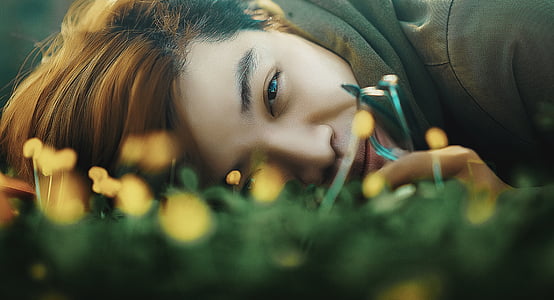 woman lying on green grass thumbnail