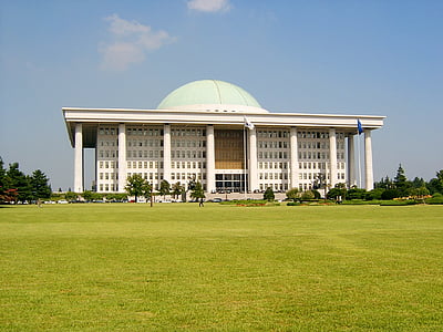 white dome concrete building in front of green grass field thumbnail