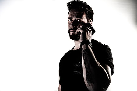 man wearing shirt holding smartphone thumbnail