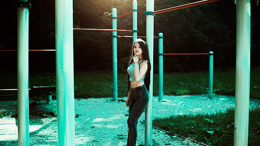 woman wearing green crop-top and black pants planning on white post thumbnail