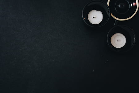 two tealight candles on glass saucers thumbnail