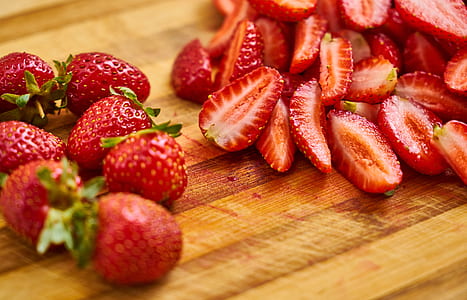 sliced strawberries on top of wood thumbnail