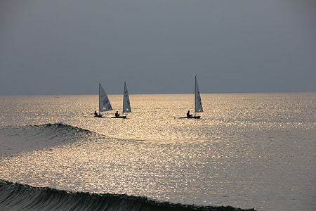 landscape photography of three sail boats on body of water thumbnail