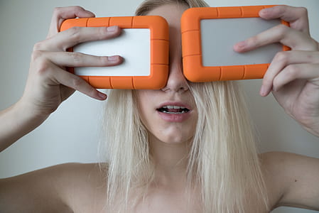 woman holding orange-and-gray cases thumbnail