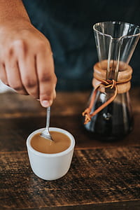 person making coffee in white ceramic cup thumbnail