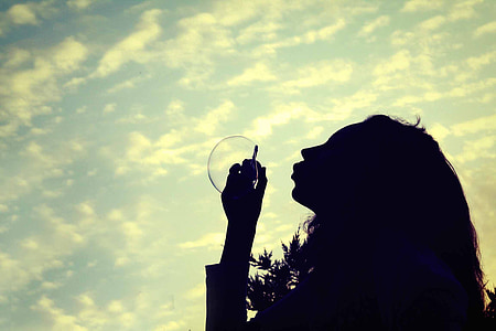 silhouette photo of woman making bubble thumbnail