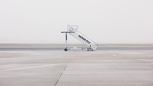 white airplane portable stairs during daytime thumbnail