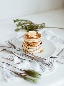 pastry food on top of plate with fork and knife on top of table with mat thumbnail