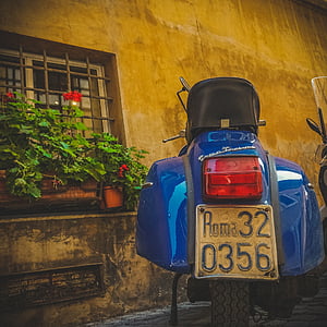 blue motorcycle parking near building thumbnail