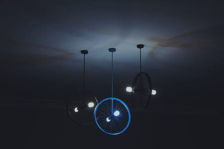 turned on ceiling light made with bike rims thumbnail