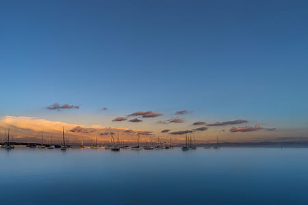 panoramic photography of sailboats on body of water under blue sky thumbnail