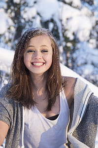 woman wearing white tank top smiling thumbnail