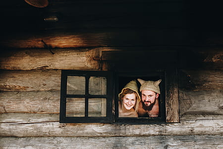 man and woman beside black window thumbnail