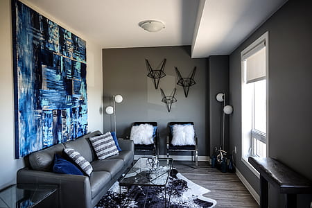 couch behind wall with abstract painting thumbnail