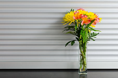 yellow chrysanthemums and pink Peruvian lilies centerpiece on black surface thumbnail