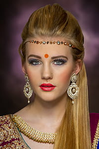 Women's Gold-colored Earrings and Red Top thumbnail