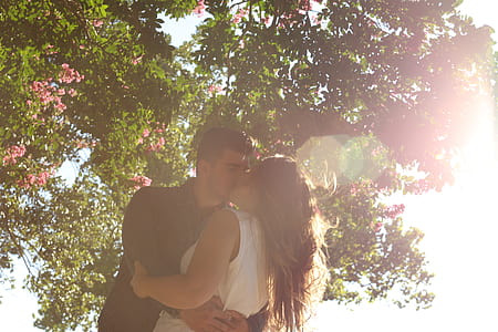 man kissing woman while holding her waist thumbnail