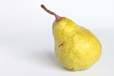 yellow pear fruit on white surface thumbnail