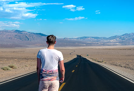man standing on gray pave road during daytime thumbnail