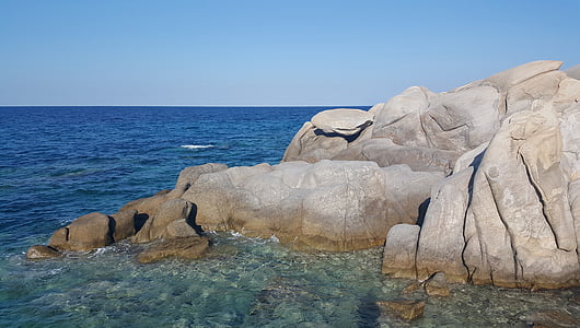rock formation on body of water thumbnail