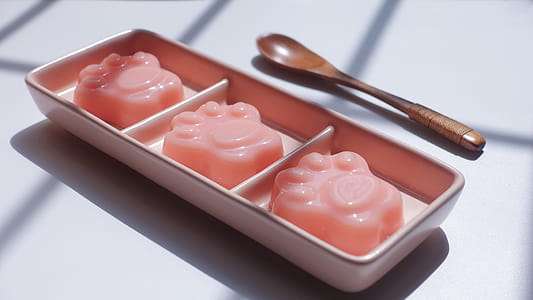 Paw Shape Jell-o on Pink Ceramic Container Near Brown Wooden Tablespoon thumbnail