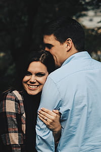 focus photography of couple smiling while hugging thumbnail