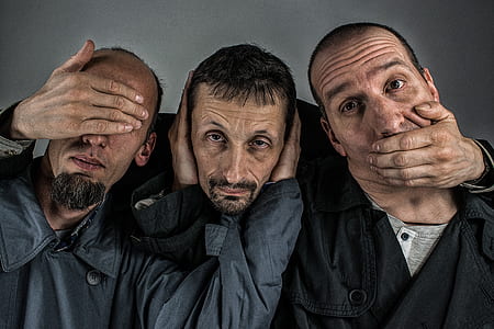 three person wearing blue and black coats thumbnail