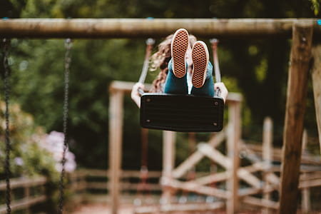 selective focus photography of girl on swing thumbnail
